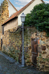 cast-iron, old street lamp on the old city wall