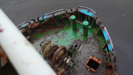 Parts of abandoned fishing boat. Clip. Abandoned boat with rusty parts on cloudy day. Abandoned...