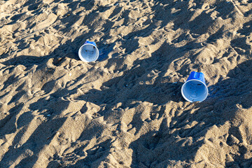 A beach in California with plastic cups left on the sand - 748215628