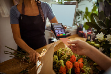 Customer making a contactless payment at a flower shop