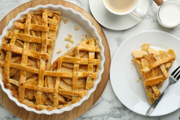 Tasty homemade quince pie served on white marble table, flat lay