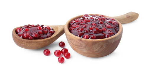Tasty cranberry sauce in bowl, spoon and fresh berries isolated on white