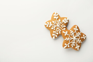 Fototapeta na wymiar Tasty Christmas cookies with icing on white background, flat lay. Space for text