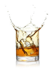 Whiskey splashing out of glass on white background