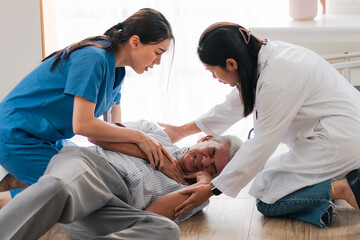 senior patient falling on the ground floor at home, Asian caregiver helping elderly older male from...