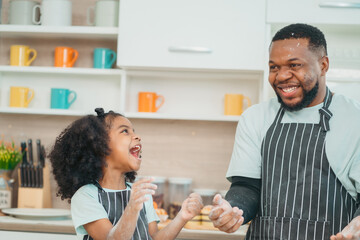 happy child family with father or mother cooking fun together for bakery bread meal in kitchen, young African little kid daughter girl and parent in love childhood lifestyle at home for food homemade
