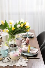 Festive table setting with beautiful flowers. Easter celebration