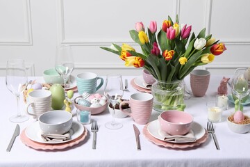 Festive table setting with beautiful flowers. Easter celebration