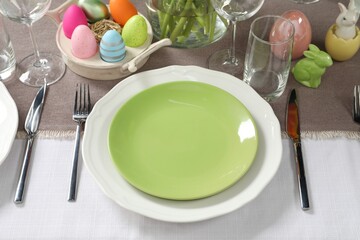 Easter celebration. Festive table setting with painted eggs