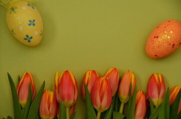 Easter, Easter egg color vibrant, spring Orthodox holiday. colorful decorated eggs in a pink basket. happy easter, gift, red yellow tulips