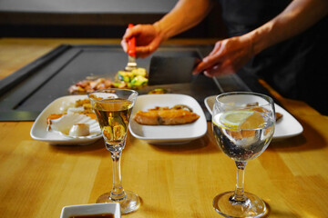 chef's hands with spatula over teppanyaki. Teppan show