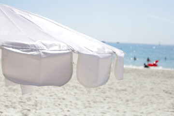 White beach umbrella on the beach  