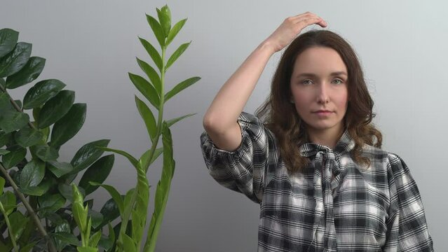 Person practicing EFT. Female tapping top of head (TH) meridian point. 