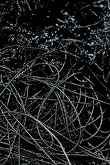 From above shot of bunch of black metal wires, modern industrial background