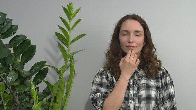Person practicing EFT. Female tapping chin (CH) meridian point. 