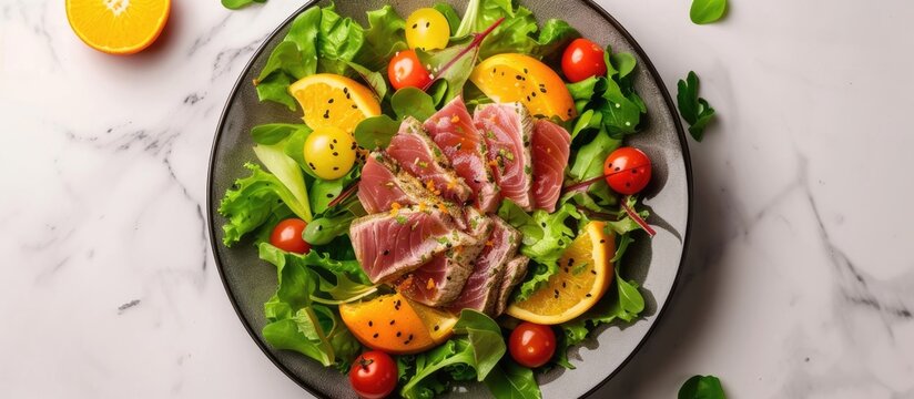 A Plate Of Food Featuring Tuna Tataki Salad With Lettuce, Tomatoes, And Oranges, Elegantly Presented On A Marble Table. The Dish Showcases A Colorful Blend Of Fresh Ingredients.