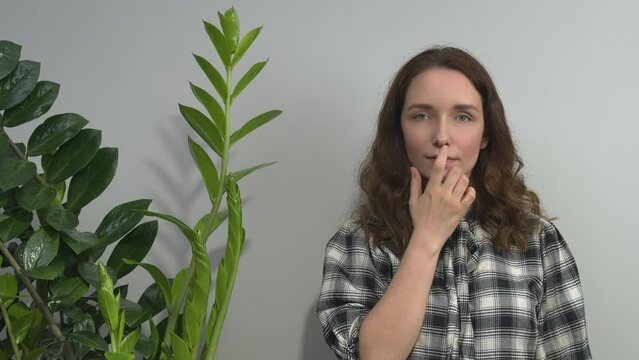Person practicing EFT. Female tapping under nose (UN) meridian point. 