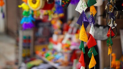 colorful tags and bracelet hanging on shop