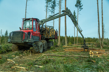 Logging equipment, forwarder loading logs of pulpwood.