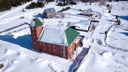 Aerial view of village in winter, countryside details. Clip. Red brick cottage and smaller houses,...