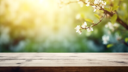 Naklejka na ściany i meble Spring background with white blossoms and sunbeams in front of a wooden table