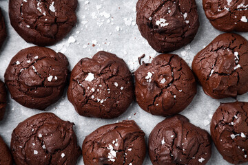 Irresistible homemade brownie cookies with cracked top and sprinkled salt flakes