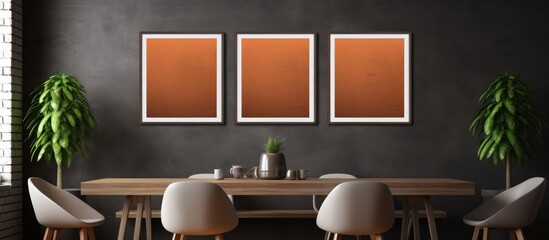 A dining room featuring a sleek table and four chairs set in a modern interior. The room is well-lit, with three blank vertical posters on the wall, adding a contemporary touch to the space.