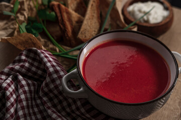 beetroot tomato soup with grilled bread, yoghurt or cream, wooden background served with table...