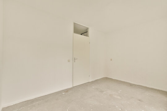 Empty room with a single white door and clean walls