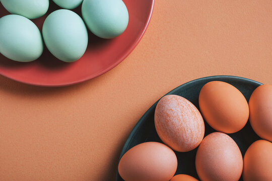Pastel Easter eggs on colorful plates for holiday celebration