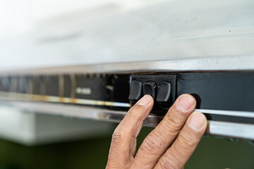 a man's hand pressing a switch 