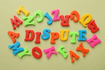 Word Dispute made of colorful letters on light green background, flat lay
