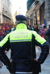 Italian city with policeman on guard with text on uniform meaning Local Police