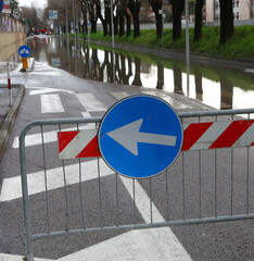 road sign with arrow due to the road being flooded after the flood in the city