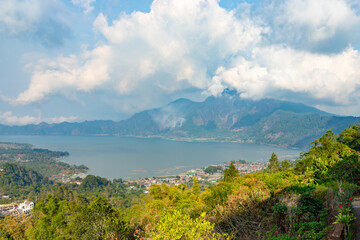 Panoramic view of a lake Batur (Danau Batur) surrounded by mountain, tropical landscape with colorful clouds in the sky. Danau Batur, Gunung Batur, Kintamani, Bali, Indonesia.