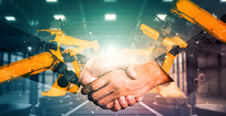 XAI Mechanized industry robot arm and business handshake double exposure. Concept of successful agreement of artificial intelligence for industrial revolution and automation process in future factory.