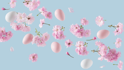 Pink and white Easter eggs adorned with cherry blossom branches, levitating against a blue...