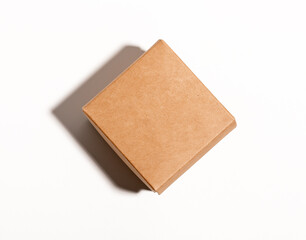 Small kraft box, square shaped package closed with lid, top view