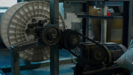 A mechanism with rotating gears. Creative. Industrial background at the workshop.