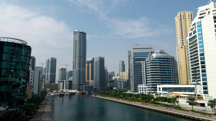 Panoramic view of high buildings with glass facade. Action. Real estate business in united arab emirates and water channel.