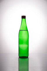 green bottle of mineral water on white background