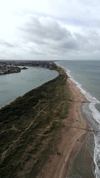 Normandy, France. 11-01-2023. Aerial view dunes separate the river from the sea. Cabourg Beach. Vertical video for social network.