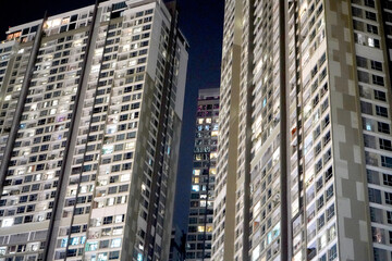 Fototapeta na wymiar Low angle view of modern skyscrapers at night, towering above