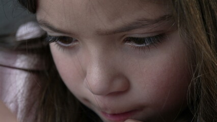 Little Girl Intensely Engaged in Artistic Drawing - macro Face Close-up. young girl completely...