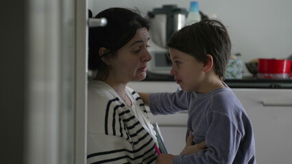Mother consoling crying hurt little boy, candid tender moment of caring parent giving an empathic...