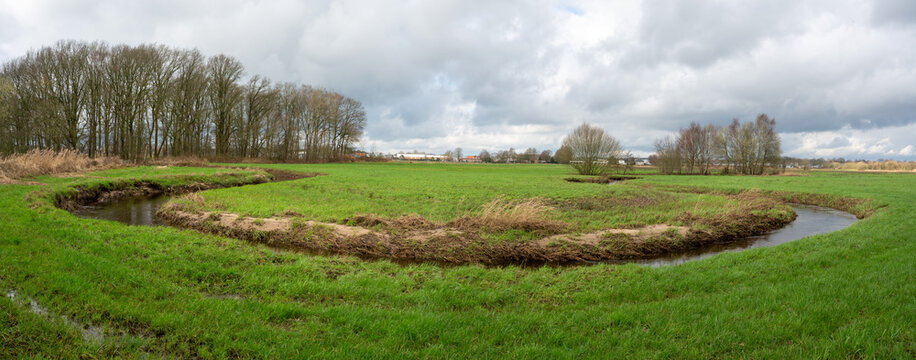 Rovertse Leij river winding through meadows outside of Goirle in The Netherlands