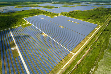 Aerial view of big sustainable electric power plant with many rows of solar photovoltaic panels for...