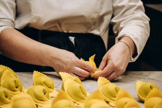 The chef prepares the cappellacci with ricotta and spinach