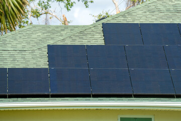Aerial view of typical american building roof with blue solar photovoltaic panels for producing clean ecological electric energy. Investing in renewable electricity for retirement income concept