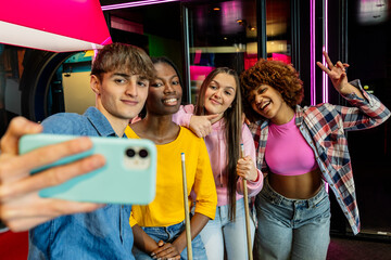 Fototapeta na wymiar Selfie of multiracial friends in arcade room playing billiard
